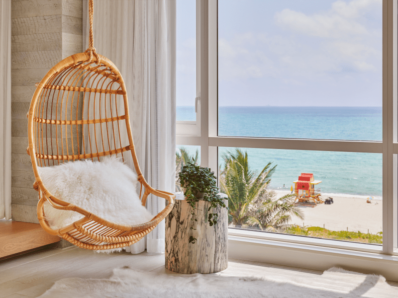 Chair hanging in a room with ocean view