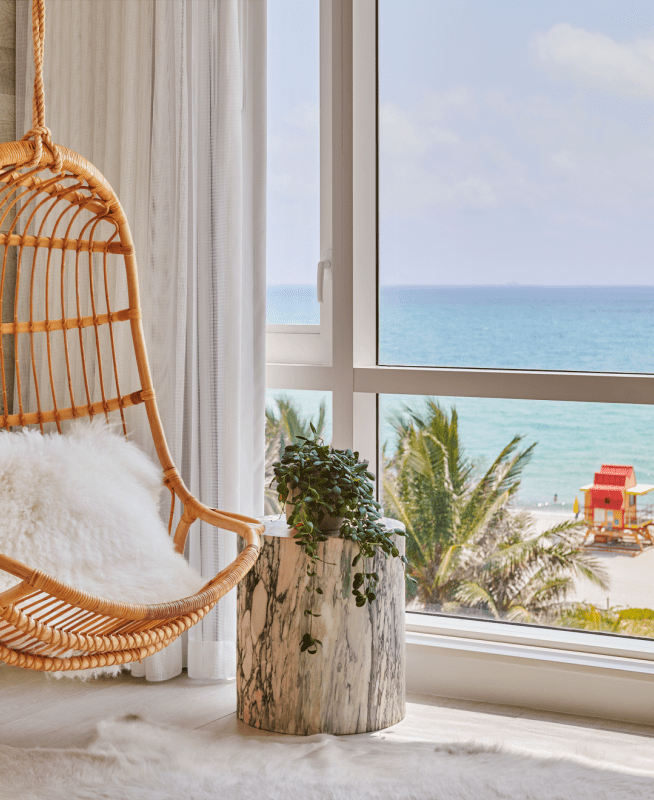 Chair hanging in a room with ocean view