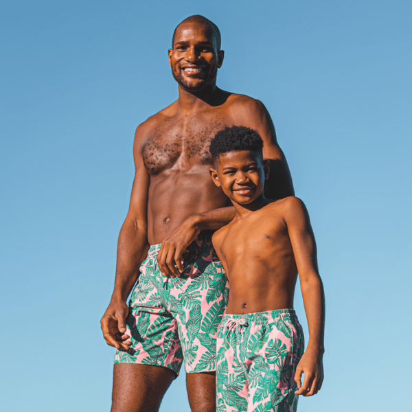 A father and son wearing matching swim suits