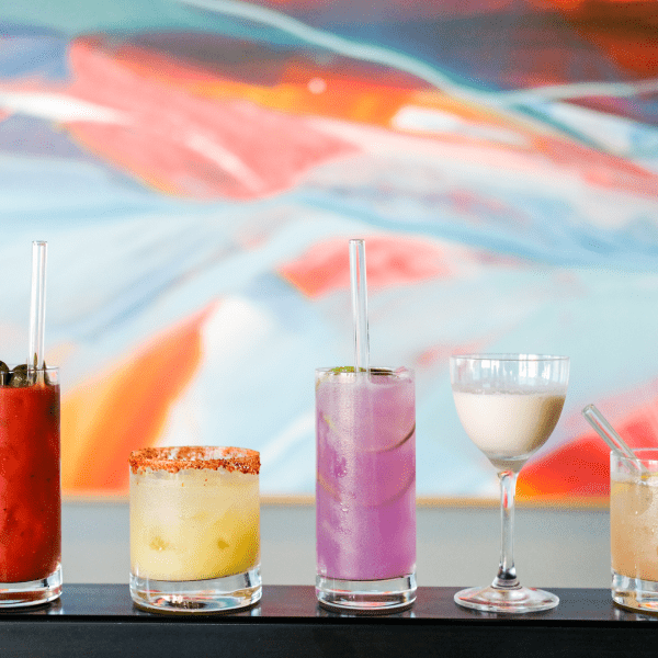 A variety of colorful cocktails aligned in a row